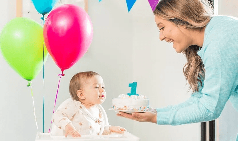 Mother giving a birthday cake to a child