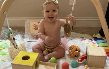 Baby on The Play Gym with playthings from Lovevery