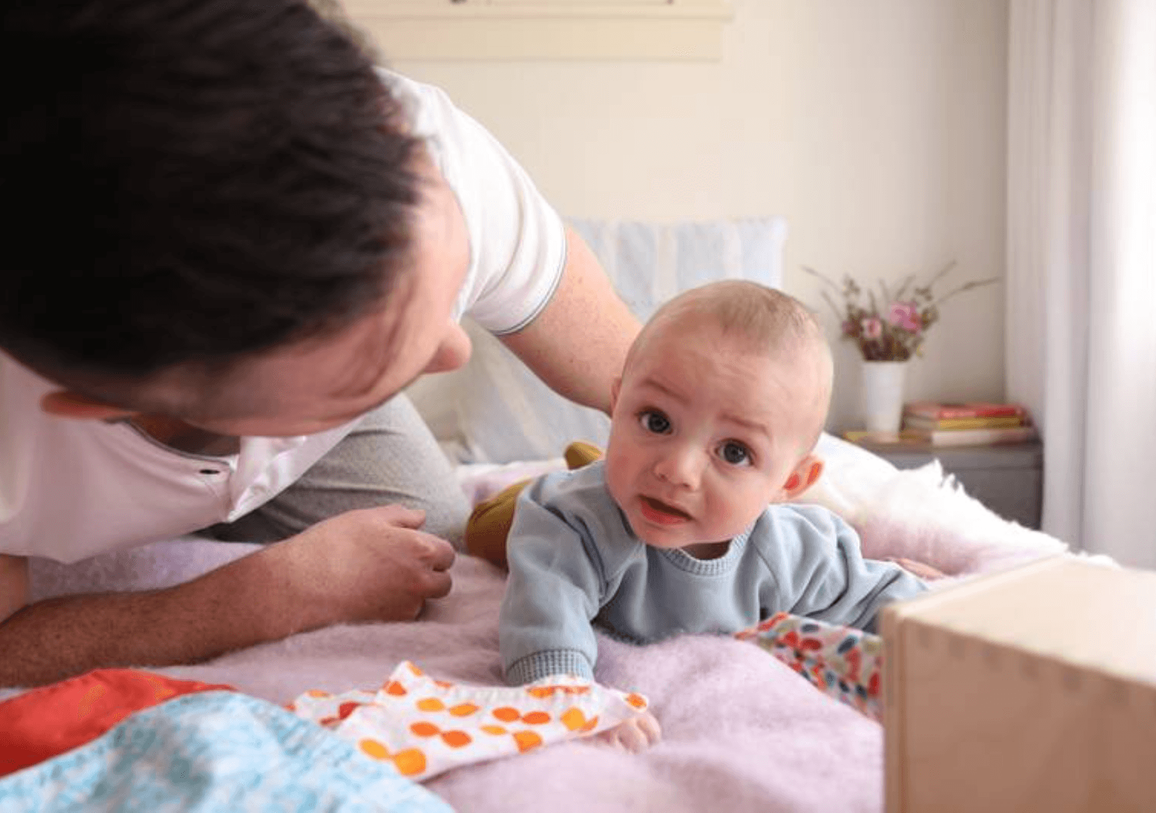 Baby doing tummy time with their father