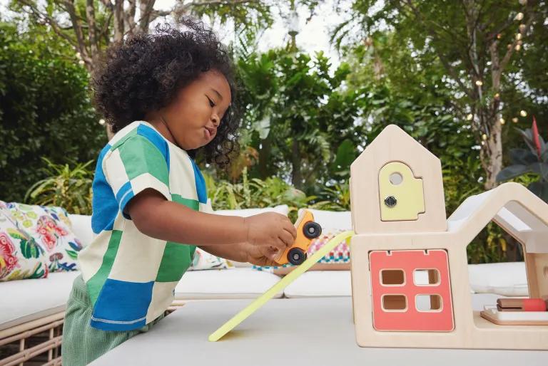 Child with the Two-Seater Speedster and Modular Playhouse from The Observer Play Kit