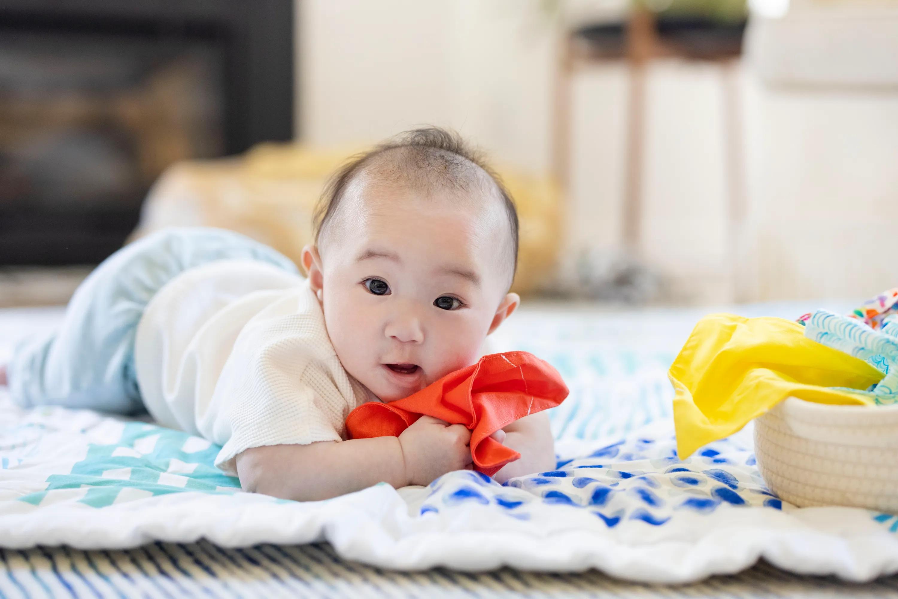 Baby holding the Magic Tissues from The Senser Play Kit